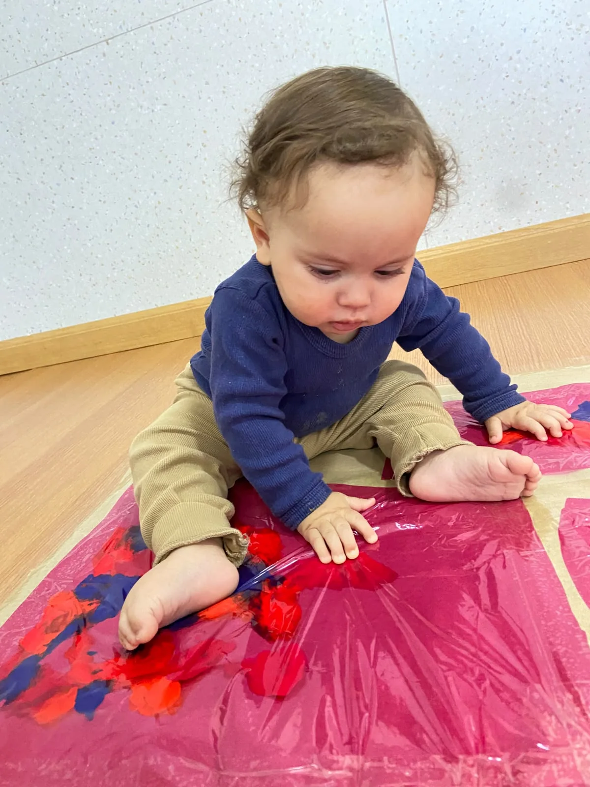 Bebê em atividade sensorial com tinta
